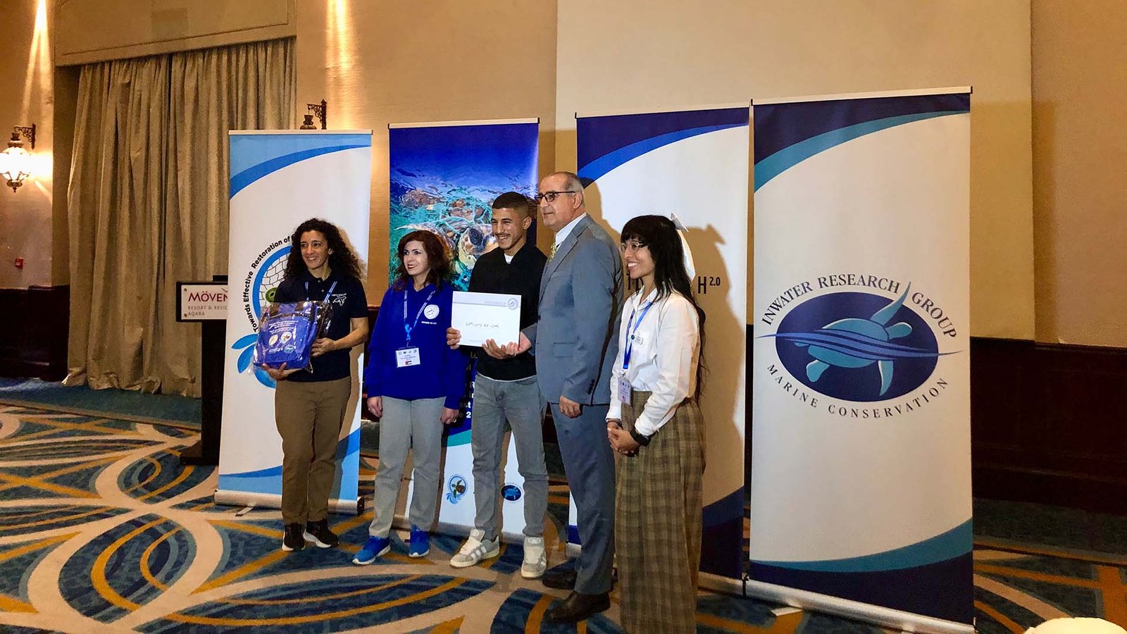 Yasin receiving a certificate of participation at the turtle conservation training